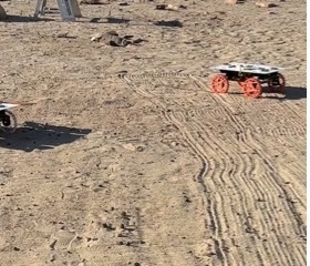 CADRE development model rovers on sandy terrain